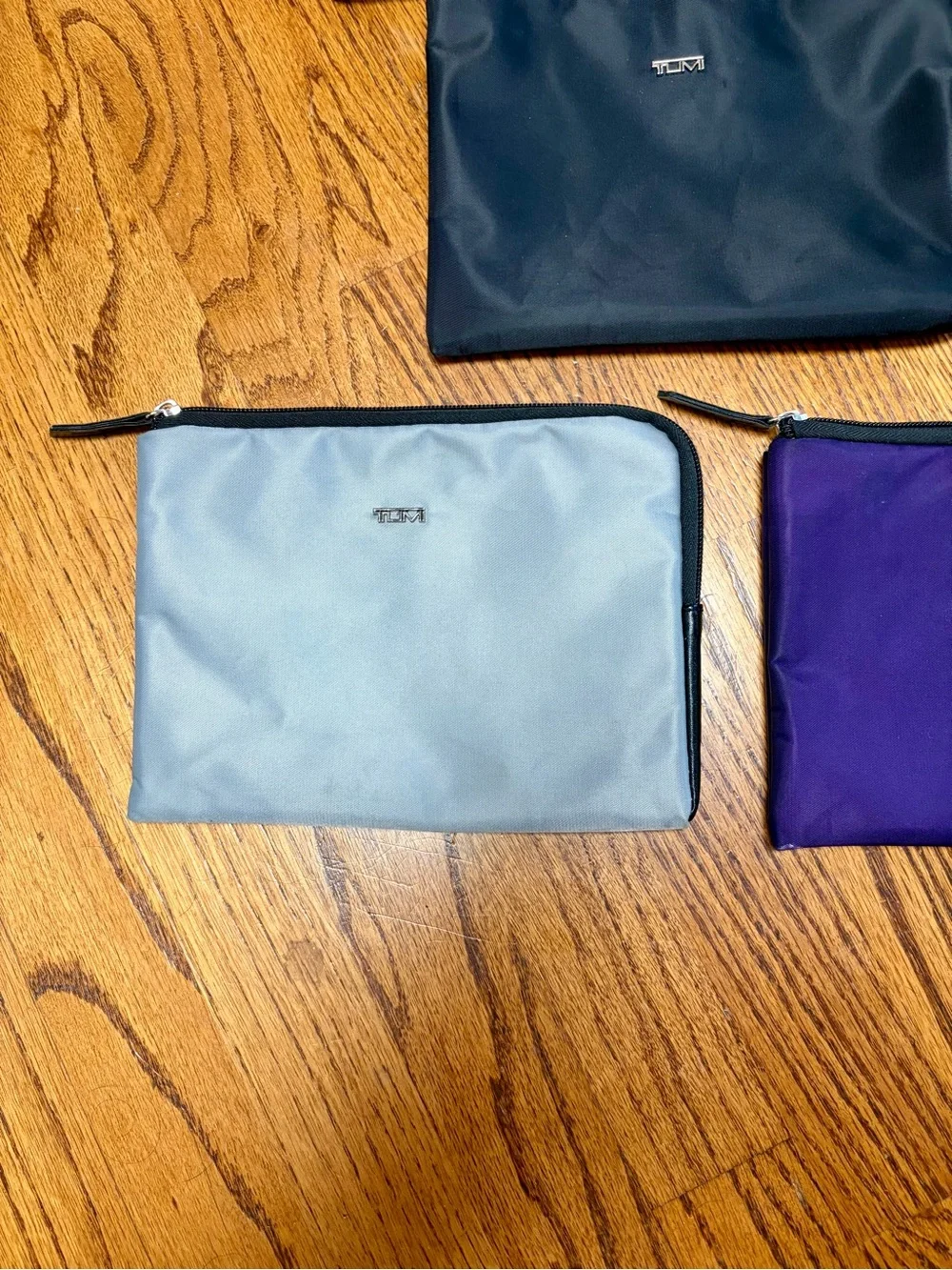 Set of Three TUMI Travel Pouches in Purple, Black & Gray